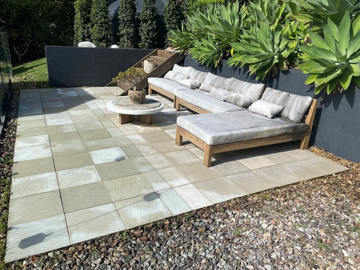 Garden designer arranging lush greenery